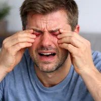 Мужчина мучается от боли сухих глаз