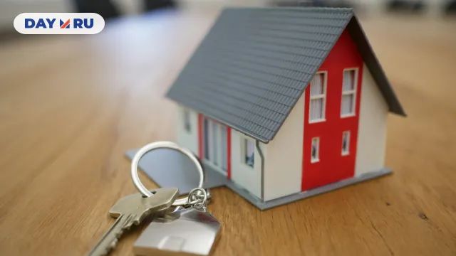 Ключи и игрушка домик на столе