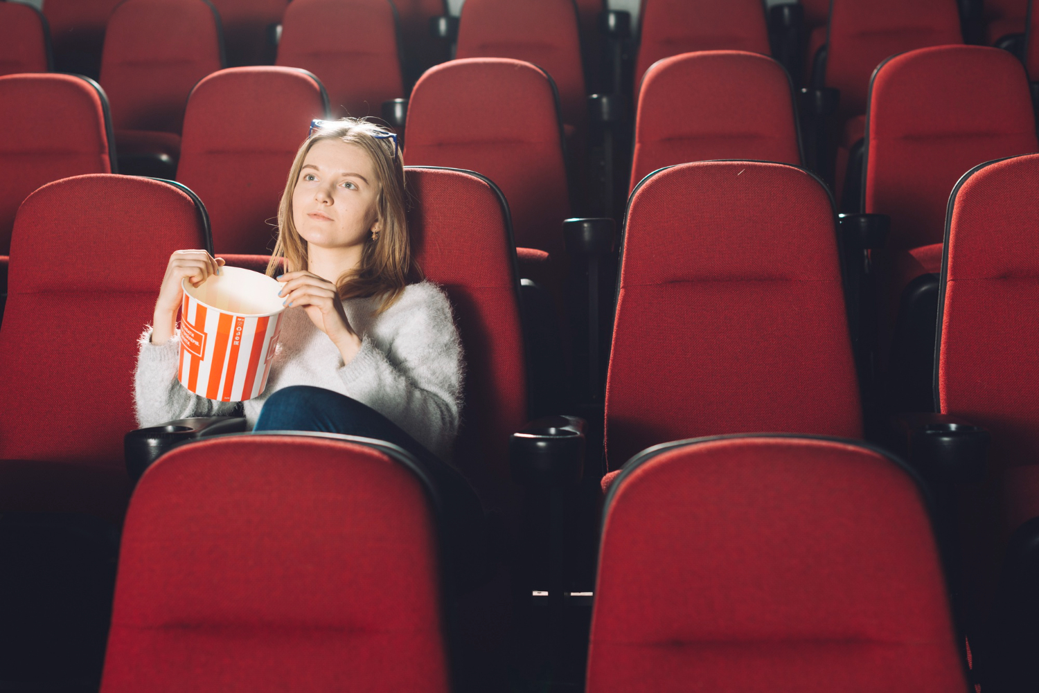 woman-with-popcorn-cinema-auditorium